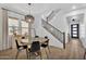 Open-concept dining room with a round table, modern lighting, and easy access to the stairway at 3415 E Arabian Dr, Gilbert, AZ 85296