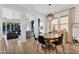 The dining area features a round wooden table, statement chandelier, and access to the living area at 3415 E Arabian Dr, Gilbert, AZ 85296