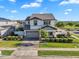 Two-story home featuring well-maintained landscaping, a gray roof, and a paved driveway at 3415 E Arabian Dr, Gilbert, AZ 85296