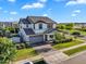 Attractive two-story home showcasing well-manicured landscaping, a gray roof, and a paved driveway at 3415 E Arabian Dr, Gilbert, AZ 85296