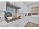 The kitchen features a stylish backsplash, a modern range hood, and a sleek gas cooktop at 3415 E Arabian Dr, Gilbert, AZ 85296