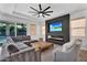 Cozy living room featuring a modern fireplace, a large TV, and stylish seating at 3415 E Arabian Dr, Gilbert, AZ 85296