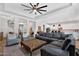 Spacious living room with a large sectional sofa, ceiling fan, and open floor plan at 3415 E Arabian Dr, Gilbert, AZ 85296