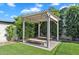 Charming pergola with built-in seating surrounded by lush greenery, creating a serene outdoor retreat at 3415 E Arabian Dr, Gilbert, AZ 85296