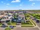 Street view of a traditional home, lush greenery, and manicured lawns under a bright sky at 3415 E Arabian Dr, Gilbert, AZ 85296
