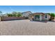 Low-maintenance backyard with gravel landscaping and a covered patio, perfect for outdoor entertaining at 42180 W Cheyenne Dr, Maricopa, AZ 85138
