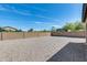 Expansive backyard featuring gravel landscaping and a tall block wall fence at 42180 W Cheyenne Dr, Maricopa, AZ 85138