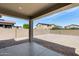 View of a spacious backyard with gravel landscaping, block wall fence, and covered patio at 42180 W Cheyenne Dr, Maricopa, AZ 85138