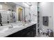Bright bathroom featuring double sinks, sleek vanity, shower, and modern fixtures at 42180 W Cheyenne Dr, Maricopa, AZ 85138