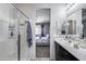 Bathroom with glass shower, neutral tile, and a view into an adjacent bedroom at 42180 W Cheyenne Dr, Maricopa, AZ 85138