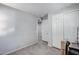 Bright bedroom with neutral walls, closet, and access to hallway at 42180 W Cheyenne Dr, Maricopa, AZ 85138