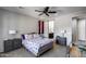 Bedroom features a sliding barn door leading to an ensuite bathroom, plus a ceiling fan and neutral color palette at 42180 W Cheyenne Dr, Maricopa, AZ 85138