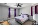 Comfortable bedroom with a ceiling fan, window, and pet cage at 42180 W Cheyenne Dr, Maricopa, AZ 85138