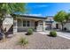 Charming single-story home with a two-car garage, covered porch, and drought tolerant landscaping at 42180 W Cheyenne Dr, Maricopa, AZ 85138