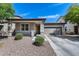 Charming single-story home with a two-car garage, covered porch, and low-maintenance desert landscaping at 42180 W Cheyenne Dr, Maricopa, AZ 85138