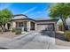 Charming single-story home with a two-car garage, covered porch, and desert landscaping at 42180 W Cheyenne Dr, Maricopa, AZ 85138