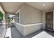 Charming front porch featuring a security door and stucco accents, creating a welcoming entry at 42180 W Cheyenne Dr, Maricopa, AZ 85138