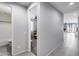 Bright hallway with tile floors leading to various rooms in the house at 42180 W Cheyenne Dr, Maricopa, AZ 85138