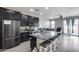 Open-concept kitchen boasts granite countertops, stainless steel appliances, and a large island with bar seating at 42180 W Cheyenne Dr, Maricopa, AZ 85138