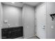 Practical mudroom space with built-in cabinets and an exterior door, providing easy access and storage at 42180 W Cheyenne Dr, Maricopa, AZ 85138