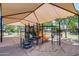 Playground featuring climbing structures, a slide, and a shade canopy at 42180 W Cheyenne Dr, Maricopa, AZ 85138