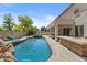 Inviting backyard features a sparkling pool, spa, outdoor kitchen, and covered patio; perfect for entertaining and relaxation at 4305 S Antonio --, Mesa, AZ 85212