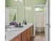 Well-lit bathroom features double sinks, wood cabinets, and tile floors at 4305 S Antonio --, Mesa, AZ 85212