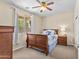 Bedroom showcasing a wooden sleigh bed, soft carpet, and a view to the backyard at 4305 S Antonio --, Mesa, AZ 85212