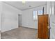 Neutral bedroom with neutral carpet, closet, shuttered window, and vintage furniture at 4305 S Antonio --, Mesa, AZ 85212