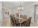 Elegant dining room with a decorative chandelier, a wooden table, and seating for eight at 4305 S Antonio --, Mesa, AZ 85212