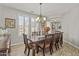 Light-filled dining room featuring a wooden table, seating for eight, and large windows at 4305 S Antonio --, Mesa, AZ 85212