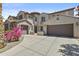 Charming house with a three-car garage, stone accents, and lush green landscaping at 4305 S Antonio --, Mesa, AZ 85212