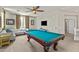 Spacious game room features a pool table, ceiling fan, neutral carpet, and white sofa at 4305 S Antonio --, Mesa, AZ 85212