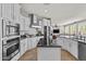 Open kitchen with white cabinets, stainless steel appliances, and a large island at 4305 S Antonio --, Mesa, AZ 85212