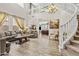 Open concept living room with staircase, wood look tile, and loft, featuring two sofas and natural light at 4305 S Antonio --, Mesa, AZ 85212