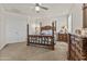 Well-lit main bedroom featuring four-poster bed, decorative light fixture, and ensuite bathroom at 4305 S Antonio --, Mesa, AZ 85212