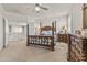 Well-lit main bedroom featuring four-poster bed, decorative light fixture, and ensuite bathroom at 4305 S Antonio --, Mesa, AZ 85212