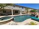 A luxurious swimming pool with a rock waterfall, slide, and a connected spa; perfect for outdoor relaxation at 4305 S Antonio --, Mesa, AZ 85212