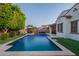 Beautiful backyard features a sparkling pool, manicured lawn, and outdoor seating area at 4337 S Helix --, Mesa, AZ 85212