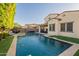 Lush backyard featuring a refreshing pool, travertine deck, covered patio, and mature trees for added privacy at 4337 S Helix --, Mesa, AZ 85212