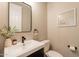 Modern powder room featuring a black framed mirror, elegant decor, and a simple color scheme at 4337 S Helix --, Mesa, AZ 85212