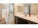 Bright bathroom featuring a soaking tub, shower, and vanity with dark wood cabinets at 4337 S Helix --, Mesa, AZ 85212