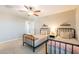 Cozy bedroom with twin beds, neutral walls, and a ceiling fan for comfort at 4337 S Helix --, Mesa, AZ 85212