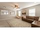 Inviting bonus room with a large couch, area rug, and natural light from the windows at 4337 S Helix --, Mesa, AZ 85212