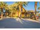Exterior shot of clubhouse framed by lush landscaping and seating at 4337 S Helix --, Mesa, AZ 85212