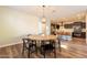 Dining area with modern chandelier, wooden dining table and views of kitchen island at 4337 S Helix --, Mesa, AZ 85212