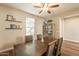 Inviting dining room with wood floors, updated lighting, and floating shelves for stylish storage at 4337 S Helix --, Mesa, AZ 85212