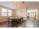 Bright dining area featuring a round wooden table with black chairs and an elegant chandelier at 4337 S Helix --, Mesa, AZ 85212