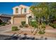 Inviting two-story home features a terracotta-tiled roof, lush landscaping, and a spacious two-car garage at 4337 S Helix --, Mesa, AZ 85212