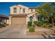 Inviting two-story home with a tiled roof, lush landscaping, and a spacious two-car garage at 4337 S Helix --, Mesa, AZ 85212